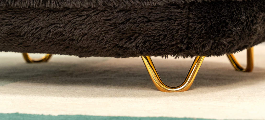 A close up image of the gold hair pin customisable feet on donut cat bed