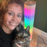 Woman and her cat in front of light up cat scratcher