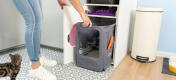 Woman cleaning the Omlet cat litter box