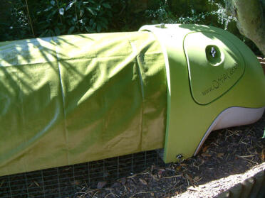 Here's a side view showing how the tarpaulin fits underneath the lip of the Eglu.  