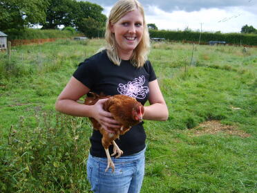 My sister Vicki, holds a chicken for the first time!