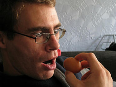Other half trying to eat raw tiny egg.