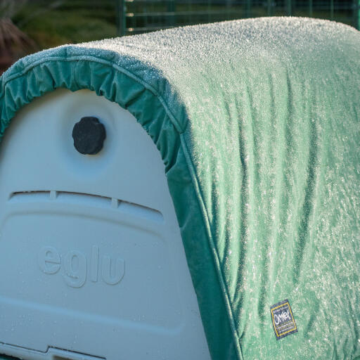 Close up of the extreme weather blanket attached to an Eglu Go up chicken coop, with a layer of frost on top